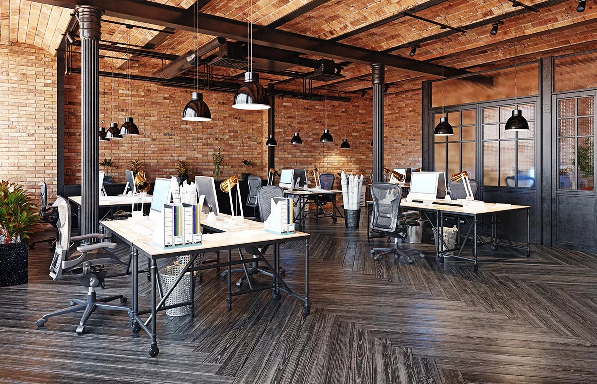 The interior of a modern commercial office building with brick walls that's been newly remodeled.